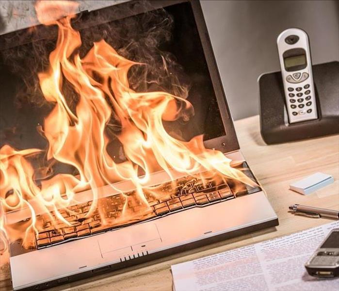 A computer on fire in an office