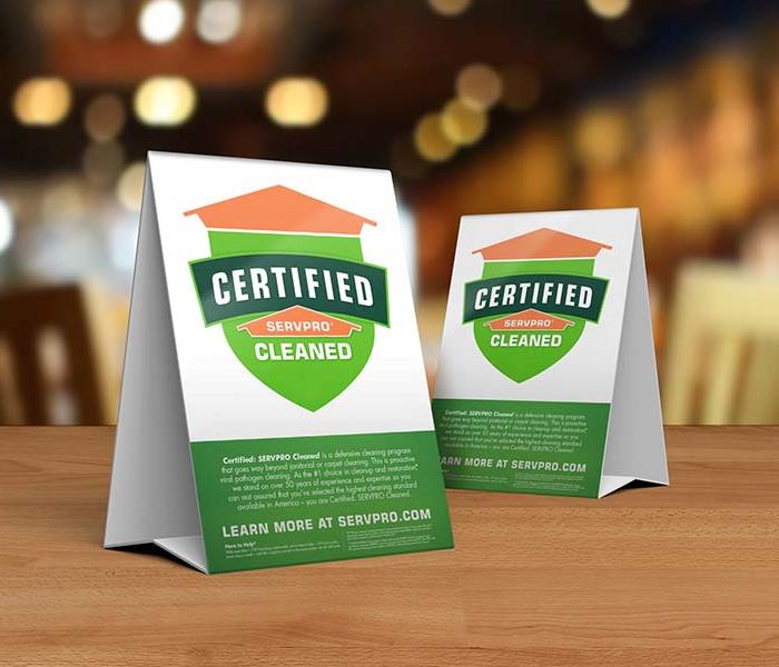 Certified: SERVPRO Cleaned table tent sitting on a table at a restaurant.
