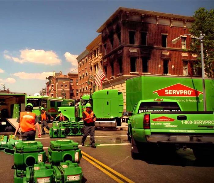 SERVPRO vehicles and equipment set up in the middle of a city setting.